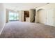 Spacious living room with neutral carpeting, leading to the kitchen and an open-plan design at 2543 Old Kent Cir, Kissimmee, FL 34758