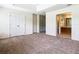 Carpeted main bedroom with double door closet and ensuite bathroom at 2543 Old Kent Cir, Kissimmee, FL 34758