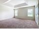 Spacious main bedroom featuring neutral paint, carpet, and tray ceiling at 2543 Old Kent Cir, Kissimmee, FL 34758