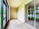 Enclosed patio area with a serene view of a lush landscape and calm water at 2543 Old Kent Cir, Kissimmee, FL 34758