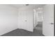 Simple bedroom with grey carpet and an open door at 4516 Ranunculus St, Lake Hamilton, FL 33851