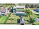 Aerial view of a modern home, pool, and backyard near a waterway at 10424 Pocket Ln, Orlando, FL 32836