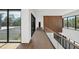 Modern hallway with glass railings, hardwood floors, and large windows at 10424 Pocket Ln, Orlando, FL 32836