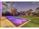 Lighted pool and relaxing backyard at night at 10424 Pocket Ln, Orlando, FL 32836