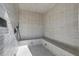 Spa-like shower with tiled walls and bench at 10424 Pocket Ln, Orlando, FL 32836