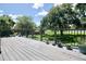 Relaxing back deck view features a black metal railing, lush green lawn, and shade trees on a sunny day at 437 Oak Haven Dr # 437, Altamonte Springs, FL 32701