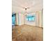 Dining room featuring neutral carpet, an elegant chandelier, and a large window with backyard views at 437 Oak Haven Dr # 437, Altamonte Springs, FL 32701