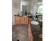 Bathroom features double sinks, a decorative mirror, and granite countertops at 8734 Crestgate Cir, Orlando, FL 32819