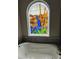 Soaking tub under a stained-glass window in an elegant bathroom at 8734 Crestgate Cir, Orlando, FL 32819