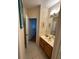 Well-lit bathroom featuring a vanity with a beige countertop, framed art, and tile flooring at 8734 Crestgate Cir, Orlando, FL 32819