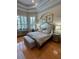 Bedroom features a tray ceiling, shutters, and an upholstered headboard at 8734 Crestgate Cir, Orlando, FL 32819