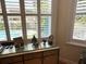 Pool view from bedroom with shutters, and a tray ceiling at 8734 Crestgate Cir, Orlando, FL 32819