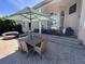 Spacious patio featuring a dining area, lounge seating, and a grill, ideal for outdoor gatherings and relaxation at 8734 Crestgate Cir, Orlando, FL 32819