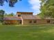 Contemporary brick and stucco home on a green lawn, featuring a clerestory window bank at 9525 Mcnorton Rd, Altamonte Springs, FL 32714