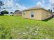 Large backyard with grassy area and neighboring homes at 328 Chelmsford Ct, Kissimmee, FL 34758