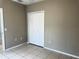 Bedroom with double door closet and tile floors at 328 Chelmsford Ct, Kissimmee, FL 34758