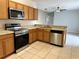 Kitchen with stainless steel appliances and wood cabinets at 328 Chelmsford Ct, Kissimmee, FL 34758