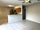 Open kitchen with breakfast bar and tile floor at 328 Chelmsford Ct, Kissimmee, FL 34758