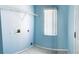 Bright laundry room with built-in shelving and window at 328 Chelmsford Ct, Kissimmee, FL 34758