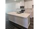 Bright kitchen features a center island, stainless appliances, white cabinetry, and wood flooring at 2608 Kinsale Ln, Ormond Beach, FL 32174