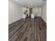 Spacious living room with wood flooring and recessed lighting, adjoining kitchen with center island at 2608 Kinsale Ln, Ormond Beach, FL 32174