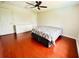 Cozy bedroom with wood floors, neutral walls, ceiling fan, and ample closet space at 9060 Heritage Bay Cir, Orlando, FL 32836