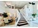 Bright foyer featuring high ceilings, staircase, dining area, and marble floors at 9060 Heritage Bay Cir, Orlando, FL 32836