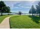 Scenic waterfront view with grassy lawn, path, and distant amusement park at 9060 Heritage Bay Cir, Orlando, FL 32836