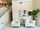 Cozy living room with white armchairs, neutral walls, and marble floors at 9060 Heritage Bay Cir, Orlando, FL 32836