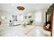 Bright living room with white furniture, a glass table, and marble floors at 9060 Heritage Bay Cir, Orlando, FL 32836