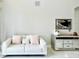 Bright living room with a white sofa, mirrored cabinet, and marble floors at 9060 Heritage Bay Cir, Orlando, FL 32836