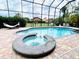 A refreshing screened-in pool and spa offer a private backyard oasis for relaxation at 9060 Heritage Bay Cir, Orlando, FL 32836