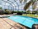 The screened-in pool area features a spa, seating, and privacy landscaping, a perfect retreat at 9060 Heritage Bay Cir, Orlando, FL 32836