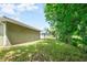 A well-maintained backyard features lush greenery and mature trees at 2240 Center St, Sanford, FL 32771