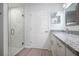 Modern bathroom featuring a glass-enclosed shower with white marble tile and granite countertops at 2240 Center St, Sanford, FL 32771