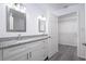 Stylish bathroom with dual sinks, granite countertops, white cabinets, and access to a walk-in closet at 2240 Center St, Sanford, FL 32771