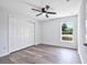 Bright bedroom with wood-look floors, a double door closet, and a window with natural light at 2240 Center St, Sanford, FL 32771