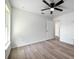 Comfortable bedroom with wood-look flooring, a ceiling fan, and a nearby ensuite bathroom at 2240 Center St, Sanford, FL 32771
