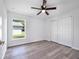 This is a bedroom with wood-look flooring, a ceiling fan, and a window offering natural light at 2240 Center St, Sanford, FL 32771
