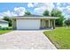 Single-story home with paver driveway, stone accents, and a two-car garage at 2240 Center St, Sanford, FL 32771