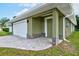 Home featuring a paver driveway, stone accents, and fresh green exterior at 2240 Center St, Sanford, FL 32771