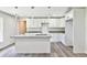 Modern kitchen with white cabinets, granite countertops, and a center island with sink at 2240 Center St, Sanford, FL 32771