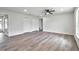 Spacious living room featuring wood-look floors, a ceiling fan, and multiple closets for ample storage at 2240 Center St, Sanford, FL 32771