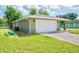 A well-maintained house with a lush green lawn and a brick paver driveway leading to the garage at 2240 Center St, Sanford, FL 32771