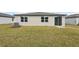 A well-maintained backyard with healthy grass, a patio door, and neatly trimmed landscaping, perfect for outdoor activities at 1709 Forest Run Ln, Auburndale, FL 33823