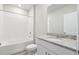 Pristine bathroom featuring granite counters, white cabinets, tile floors, and a shower-tub combo at 1709 Forest Run Ln, Auburndale, FL 33823