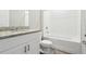 Bathroom featuring a vanity with a speckled countertop, a toilet, and a shower-tub combination with tiled walls at 1709 Forest Run Ln, Auburndale, FL 33823