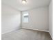 Bedroom with a window allowing natural light, neutral walls and carpet, and electrical outlets visible at 1709 Forest Run Ln, Auburndale, FL 33823