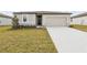 Charming single-story home featuring a well-maintained lawn, neutral color scheme, and attached garage at 1709 Forest Run Ln, Auburndale, FL 33823
