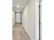 Bright hallway with tile floors, recessed lighting, neutral paint, and white doors at 1709 Forest Run Ln, Auburndale, FL 33823